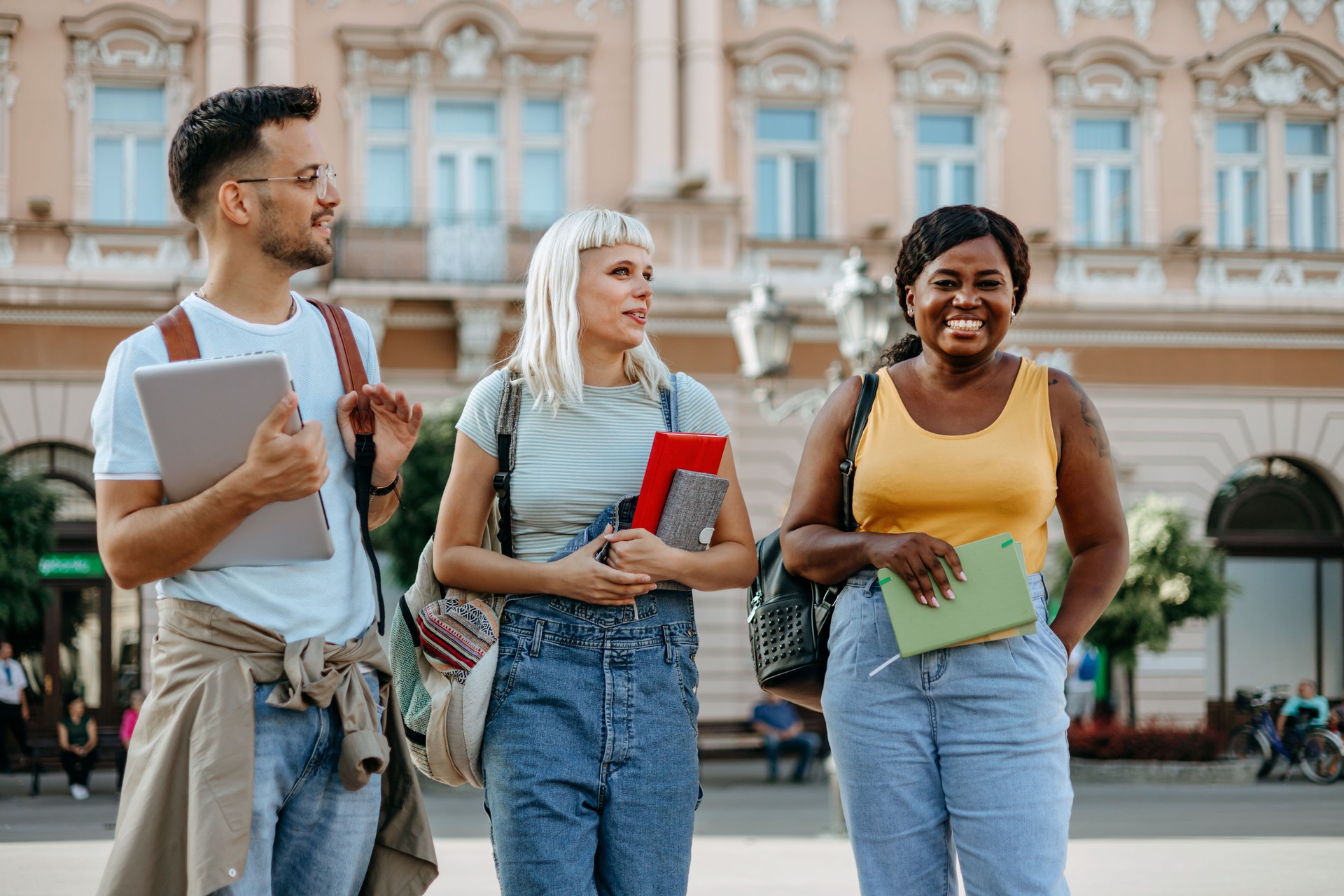 A multiracial group of college friends having a cheerful conversation